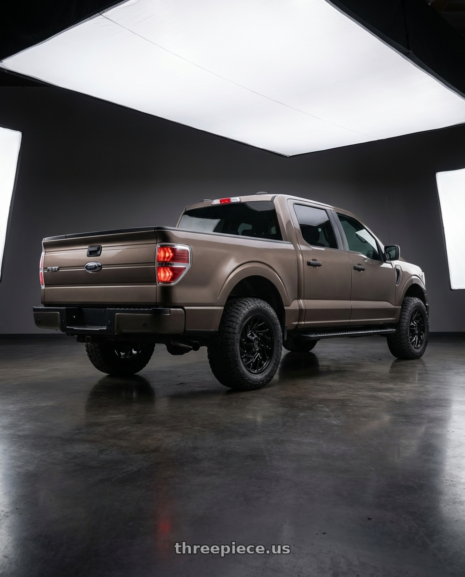 2013 Ford F-150 with Gear Off Road 769B 6X135/6x139.7 20x9 +18 Gloss Black wheels rear three quarter view meaty tires