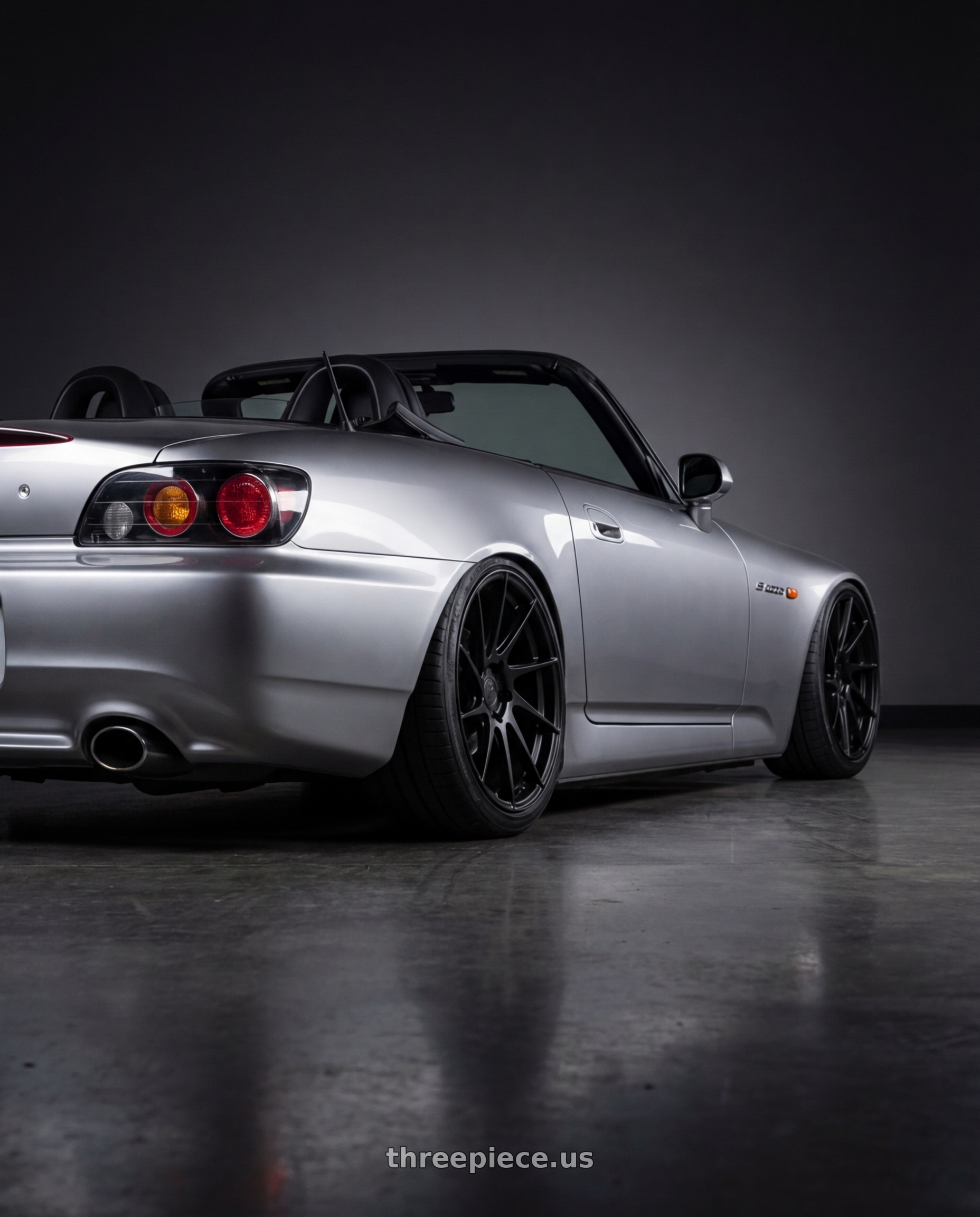 2009 Honda S2000 with Aodhan AH09 5x114.3 18x8.5 +35 Matte Black wheels rear three quarter view slight stretch tires
