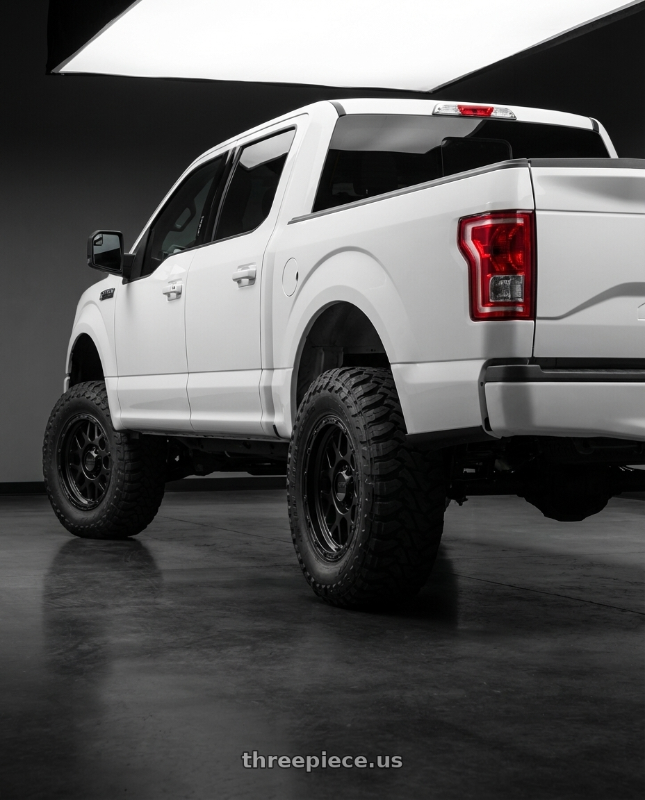 2017 ford f150 sxt with KMC KM535 GRENADE OFF-ROAD 6X139.7 17X8.5 +0 MATTE BLACK wheels rear three quarter view meaty tires