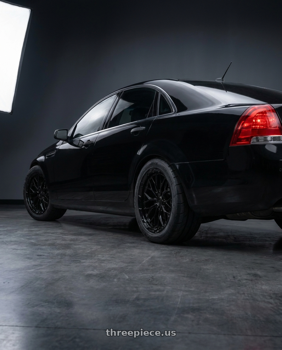 2014 Chevrolet Caprice PPV with DOLCE PERFORMANCE MAGARI 5x120 19x9.5 +40 Gloss Black wheels rear three quarter view square tires