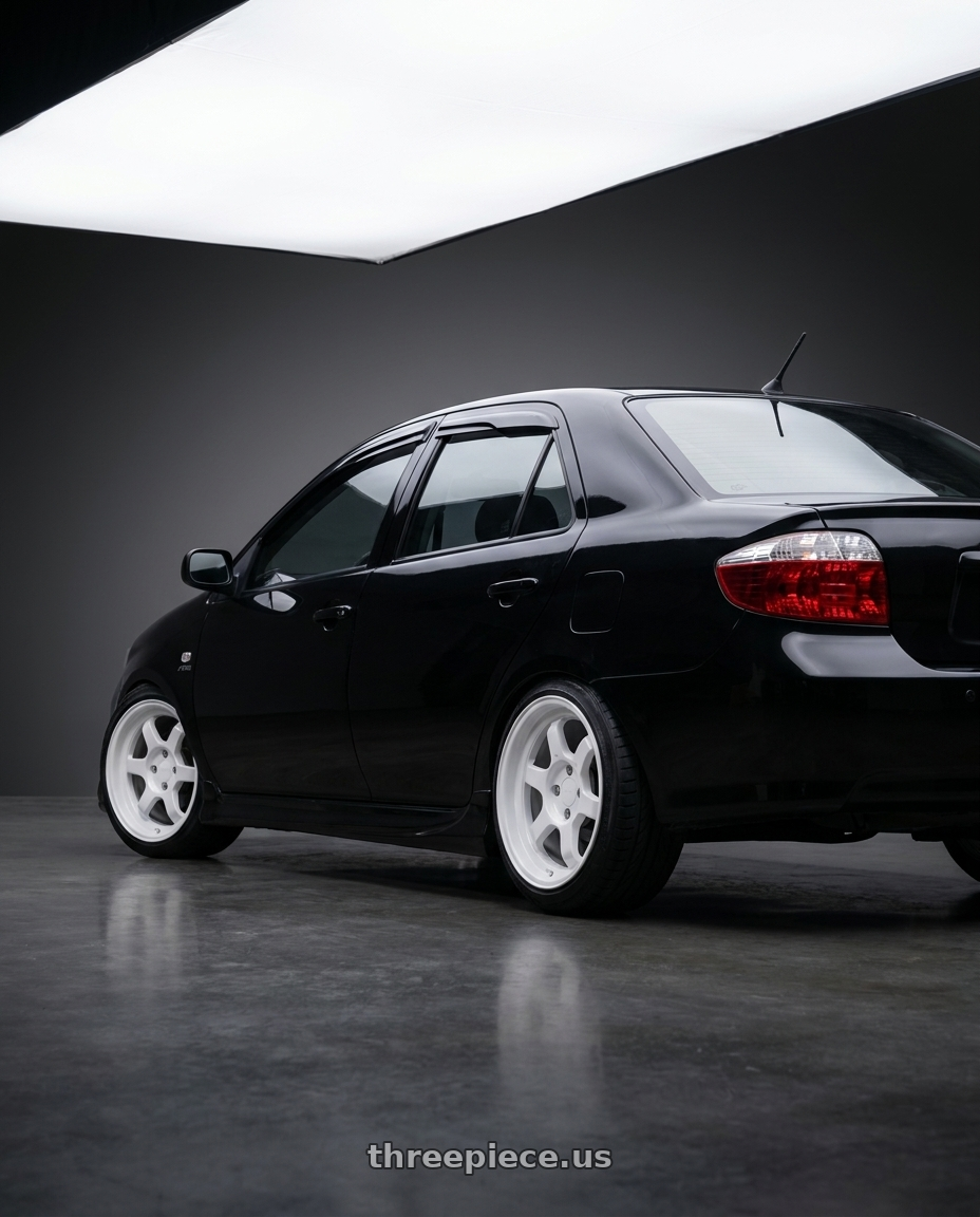 2007 Toyota Vios Black with 9six9 SIX-1 Deep 4x100 15X8 +20 Competition White wheels rear three quarter view slight stretch tires