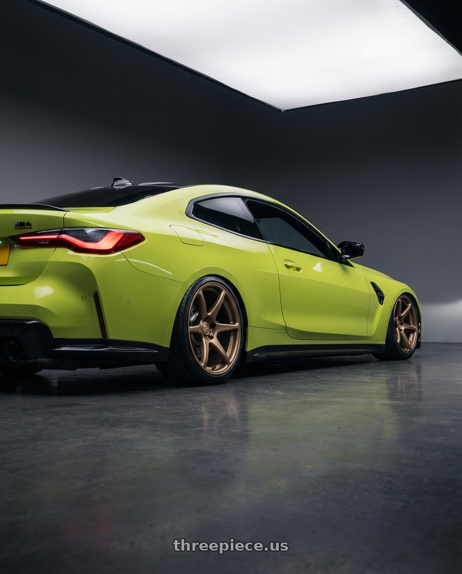 2024 BMW M4 G82 with Kansei K11B Tandem 5X112 19x9.5 22 Bronze wheels rear three quarter view slight stretch tires