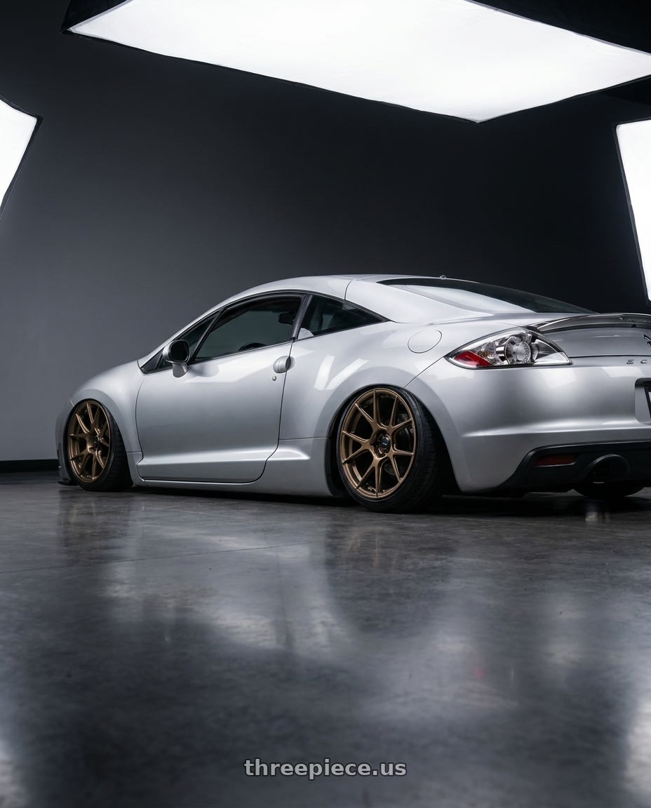 2010 Mitsubishi Eclipse with Konig Ampliform 5x114.3 18x8.5+35 Gloss Bronze wheels rear three quarter view slight stretch tires