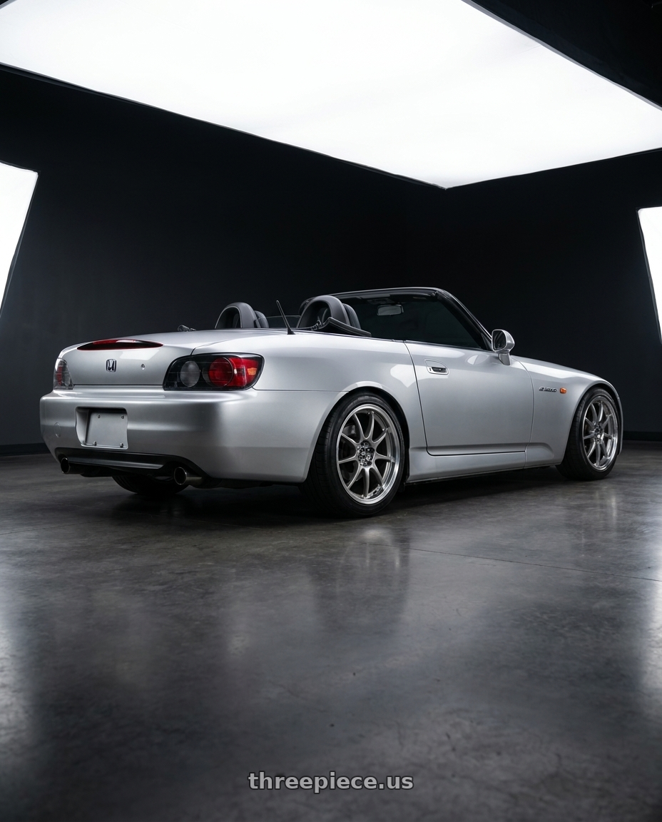 2002 Honda s2000 with Enkei J10 4x100/114.3 15x6.5+38 Silver w/ Machined Lip Dia wheels rear three quarter view square tires