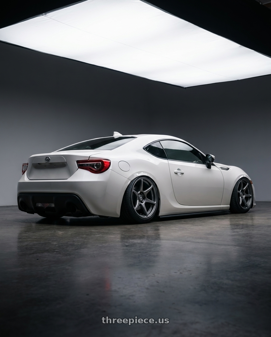 2016 Scion FR-S with Kansei K11G Tandem 5X100 18x10.5 12 Gunmetal wheels rear three quarter view slight stretch tires