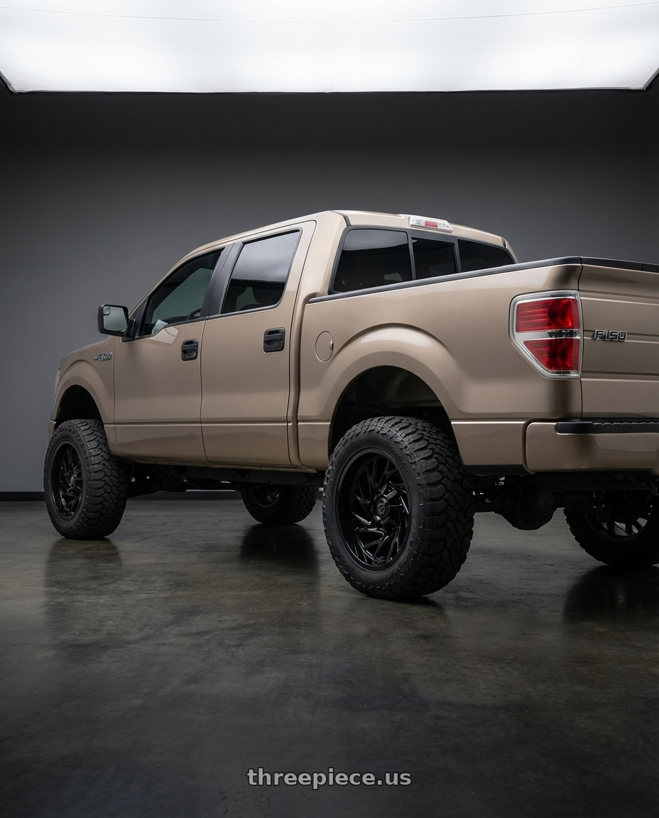 2013 Ford F-150 with Gear Off Road 769B 6X135/6x139.7 22x10 -19 Gloss Black wheels rear three quarter view meaty tires