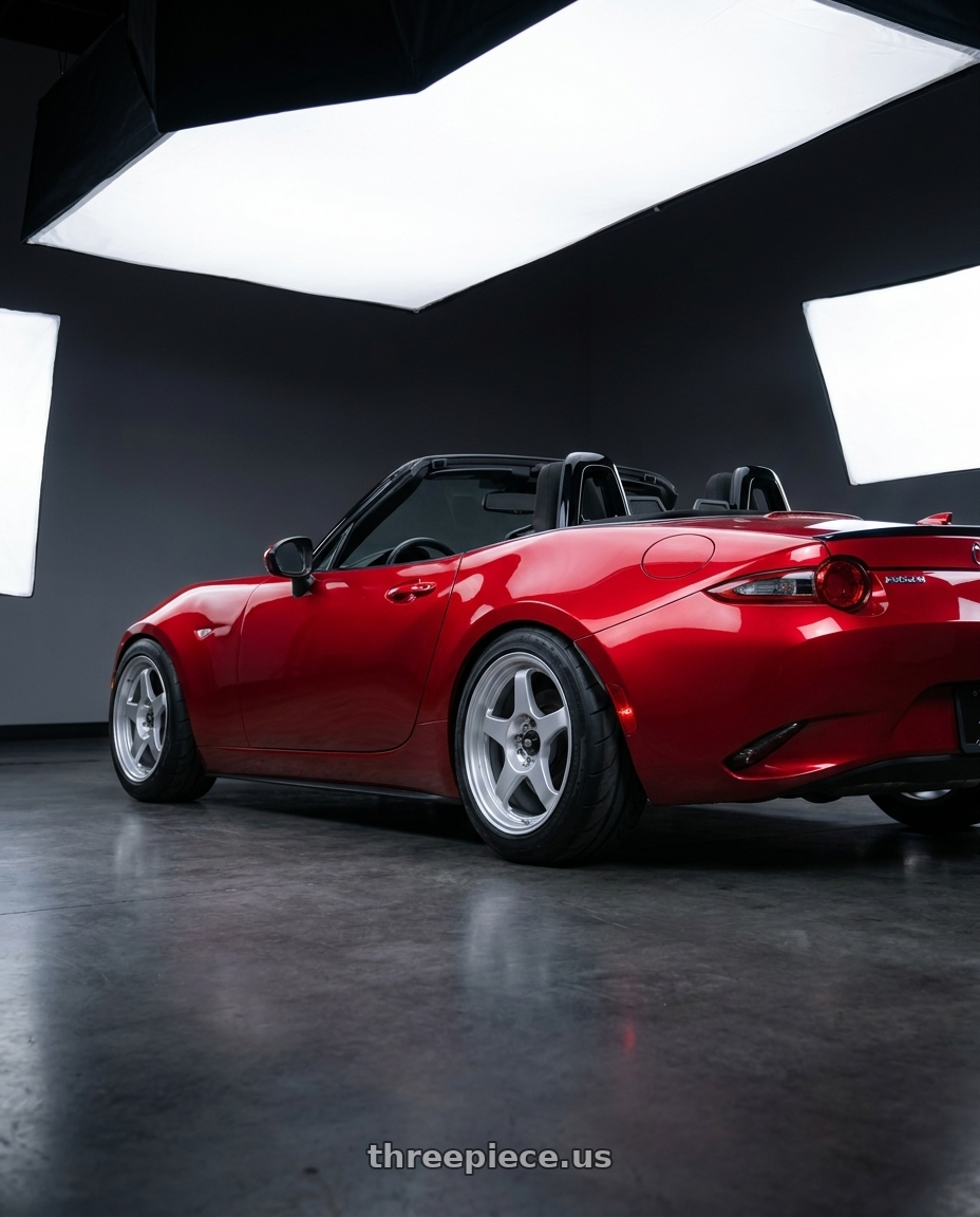 2016 Mazda Miata with MST Wheels MT29 4X100 16X7.0 +38 Glossy Silver wheels rear three quarter view meaty tires