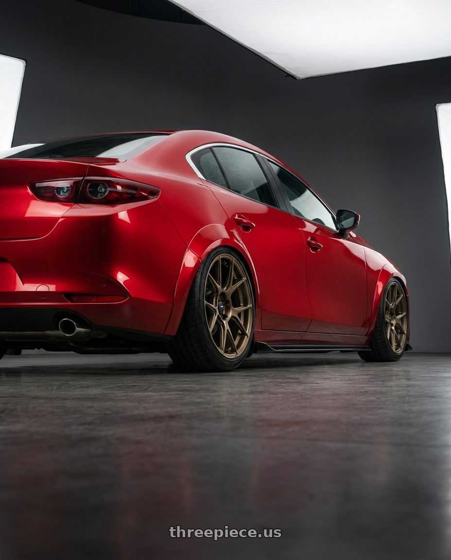 2021 Mazda3 4door with Konig Ampliform 5x114.3 19x9.5+25 Gloss Bronze wheels rear three quarter view slight stretch tires