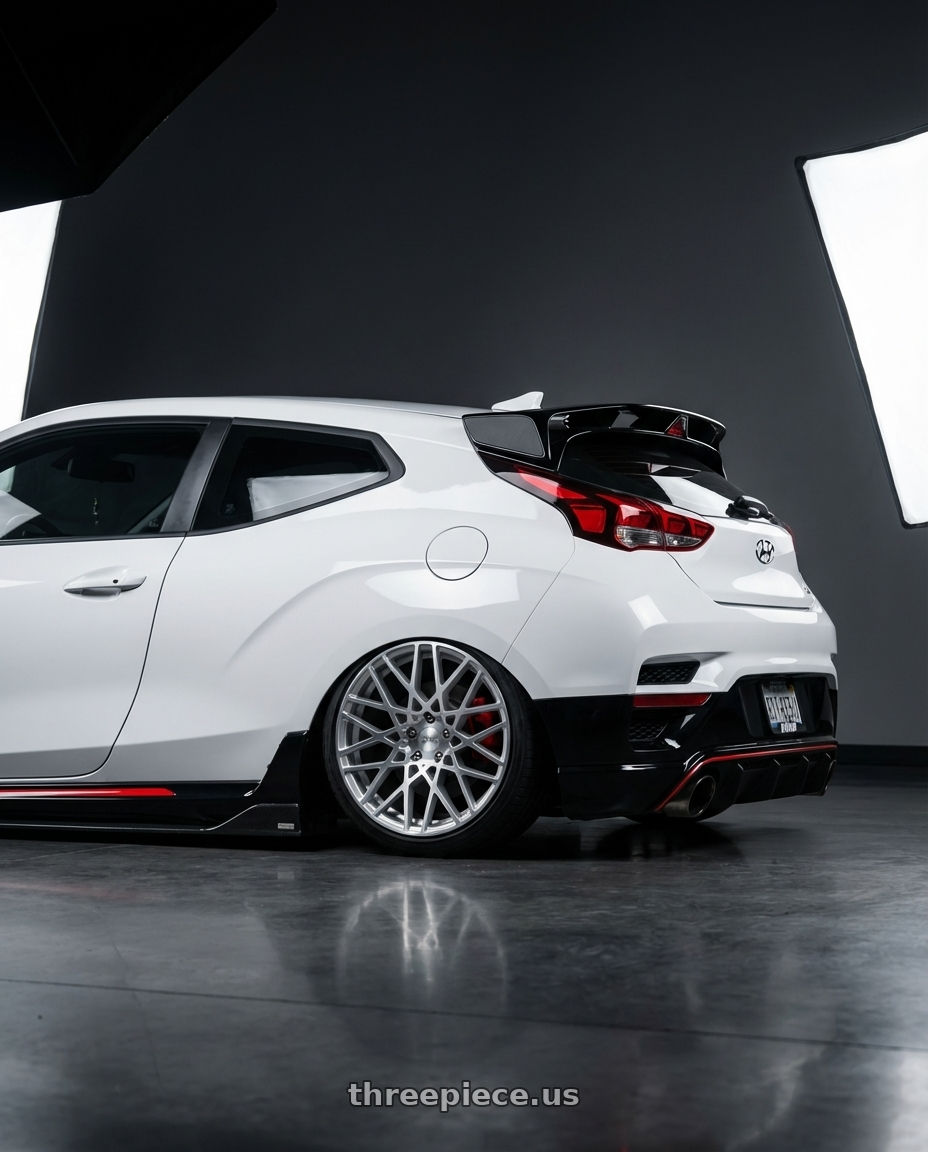 2022 Veloster N lunar white with Rotiform 1PC R110 BLQ 5X100 18X8.5 +35 GLOSS SILVER MACHINED wheels rear three quarter view slight stretch tires