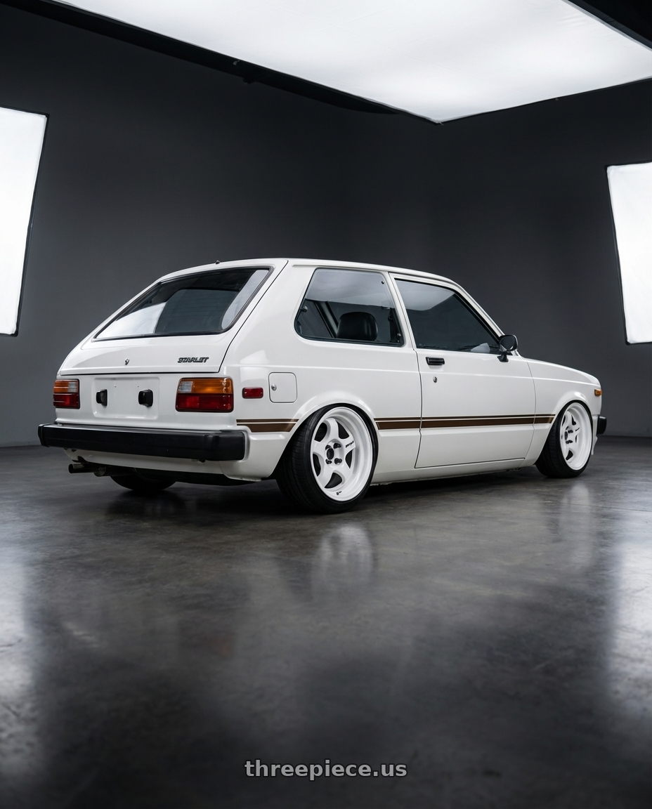 1981 toyota starlet with Work Meister S1 2P 4x100 15x6.5+22 A Disk Black wheels rear three quarter view slight stretch tires