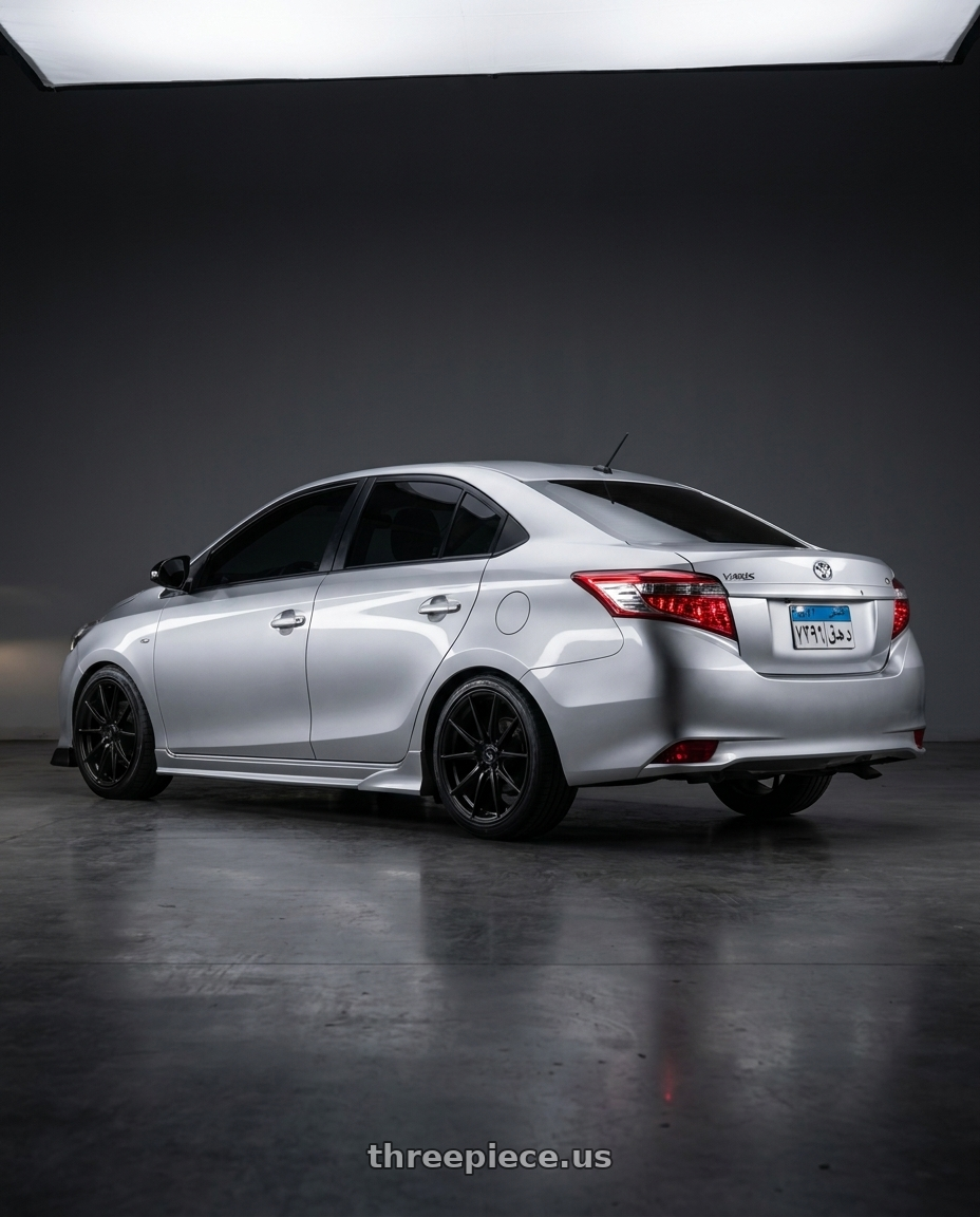 2016 toyota yaris with Konig Oversteer 5x114.3 18x9+35 Gloss Black wheels rear three quarter view square tires