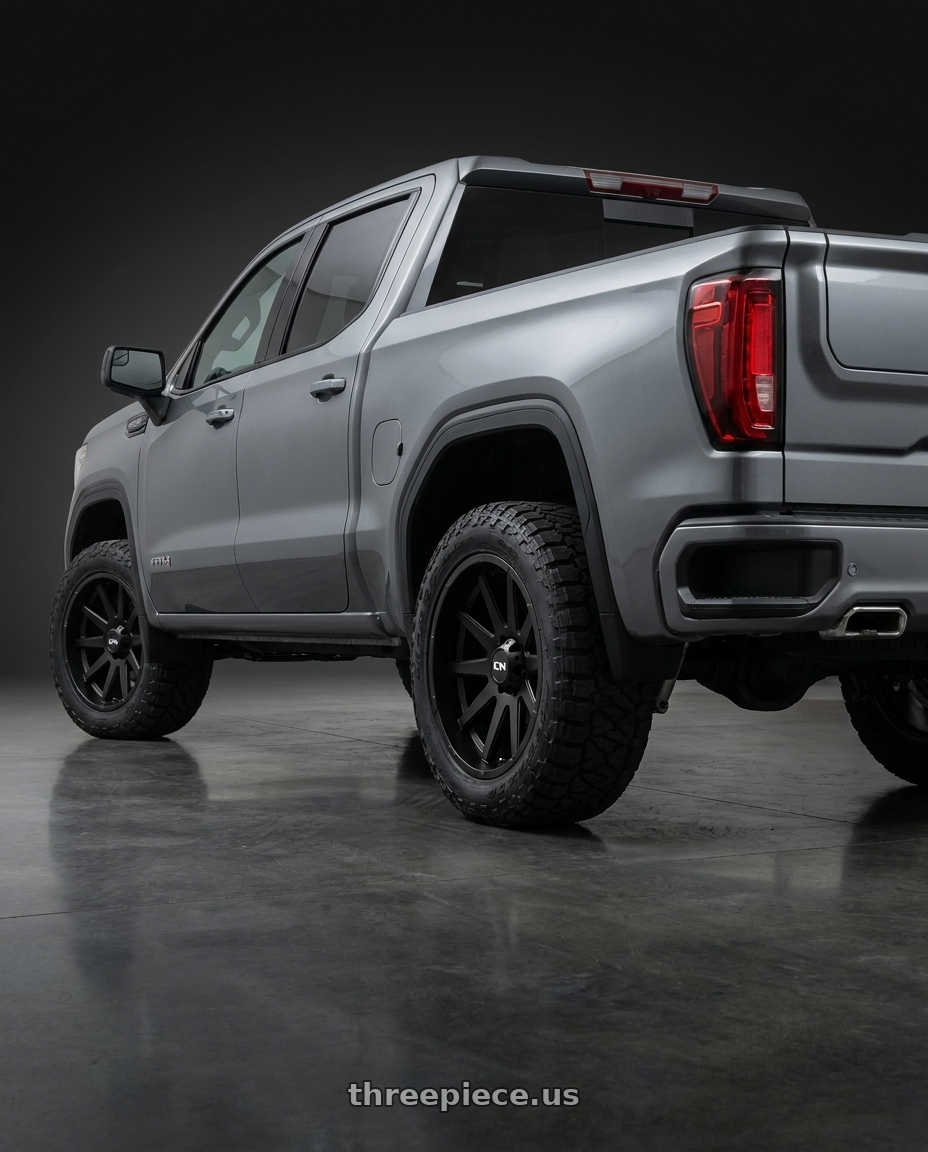 2021 GMC Sierra 1500 AT4 with Ion Type 143 6x139.7 20x10-19 Matte Black wheels rear three quarter view square tires