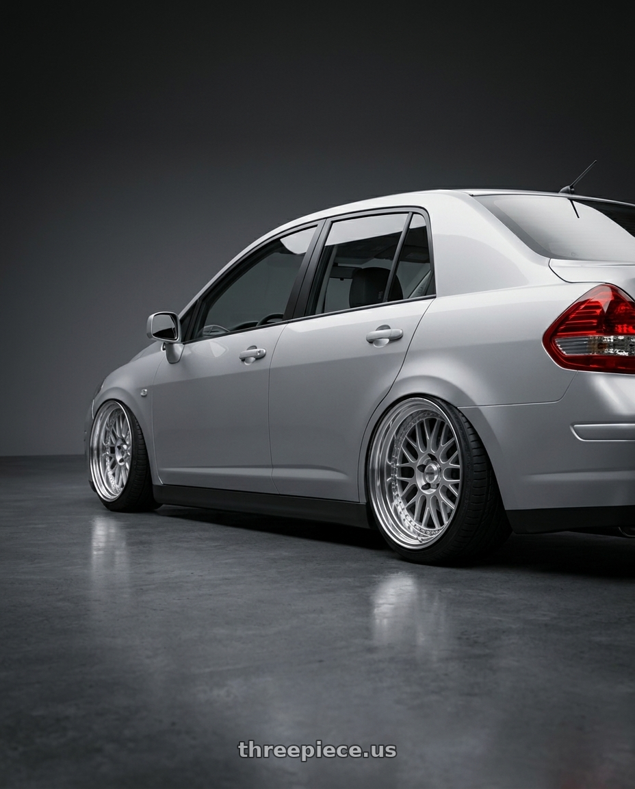 2007 Nissan Tiida with Work Meister M1 3p 4x114.3 16x6.5+37 O Disk Silver wheels rear three quarter view square tires