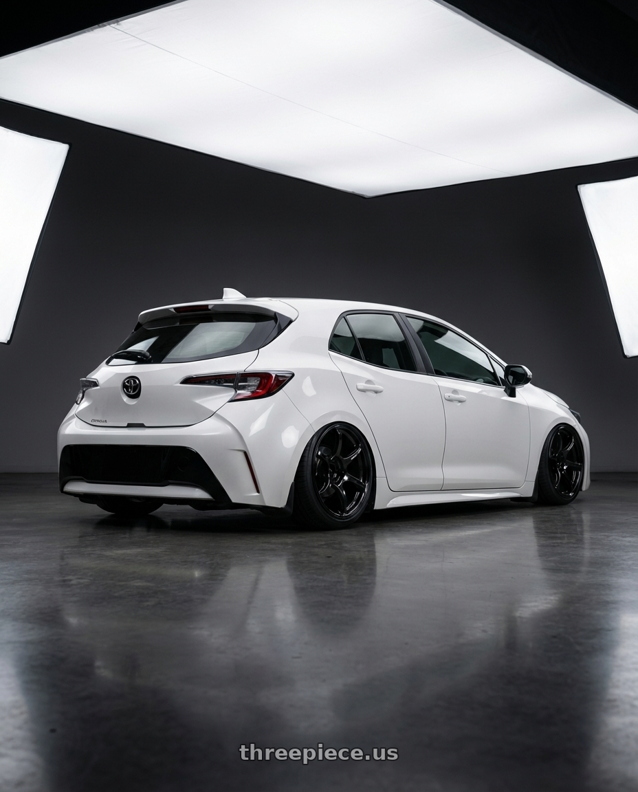 2023 Toyota Corolla Hatchback with Advan RGIII 5x114.3 18x9.0+25 Gloss Black wheels rear three quarter view slight stretch tires