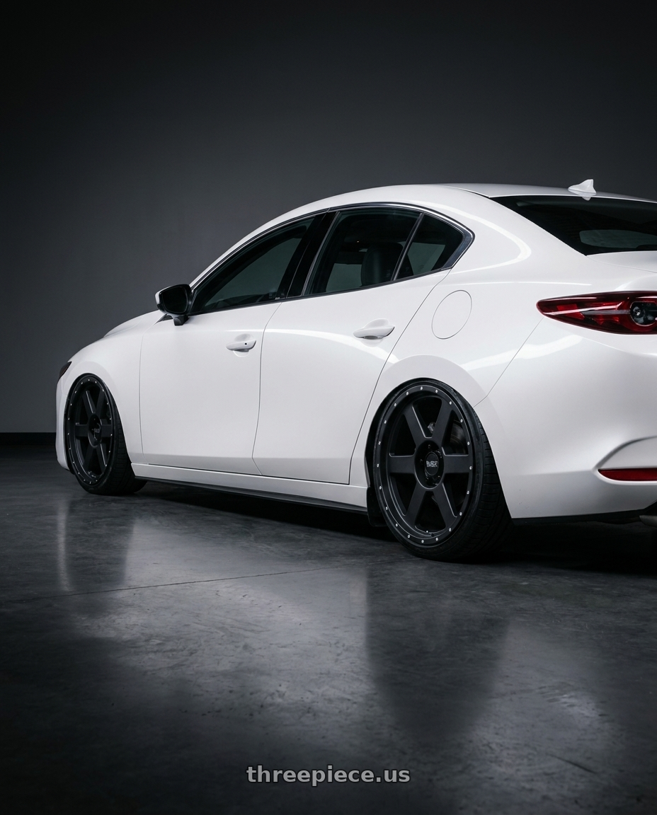 2022 Mazda3 white with Black Rock 965B 6X135 20x9 +12 Matte Black wheels rear three quarter view slight stretch tires