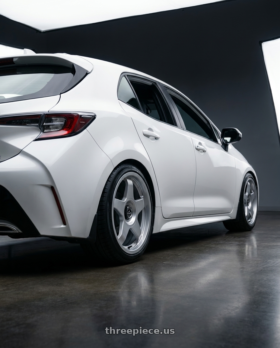 2023 Toyota Corolla Hatchback with fifteen52 CHICANE 5x114.3 / 5x100 18x8.5 +35 SPEED SILVER (GLOSS SILVER) wheels rear three quarter view square tires