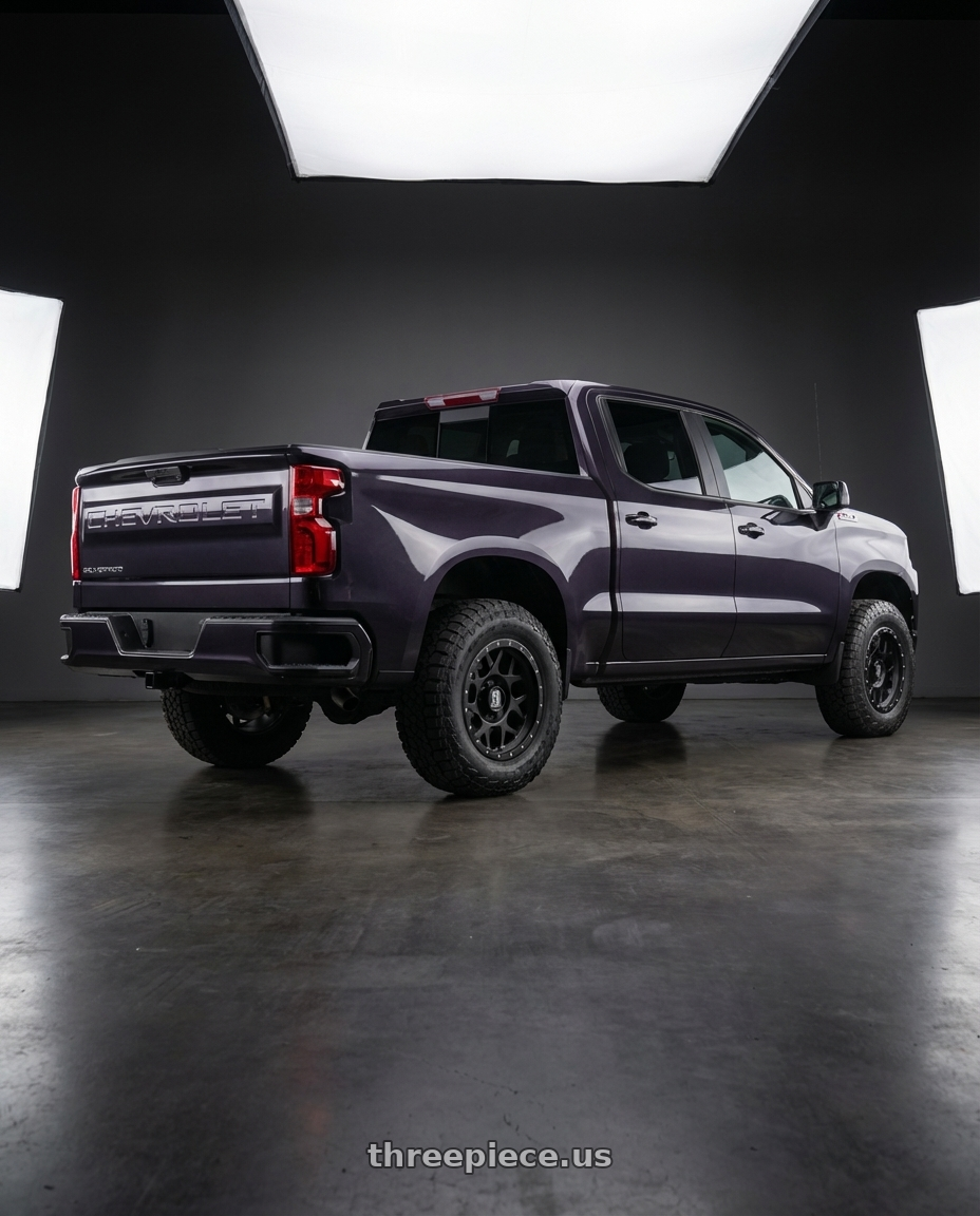 2023 Chevrolet Silverado 1500 with XD XD127 BULLY 6X139.7 20X9 +18 SATIN BLACK WITH REINFORCING RING wheels rear three quarter view meaty tires