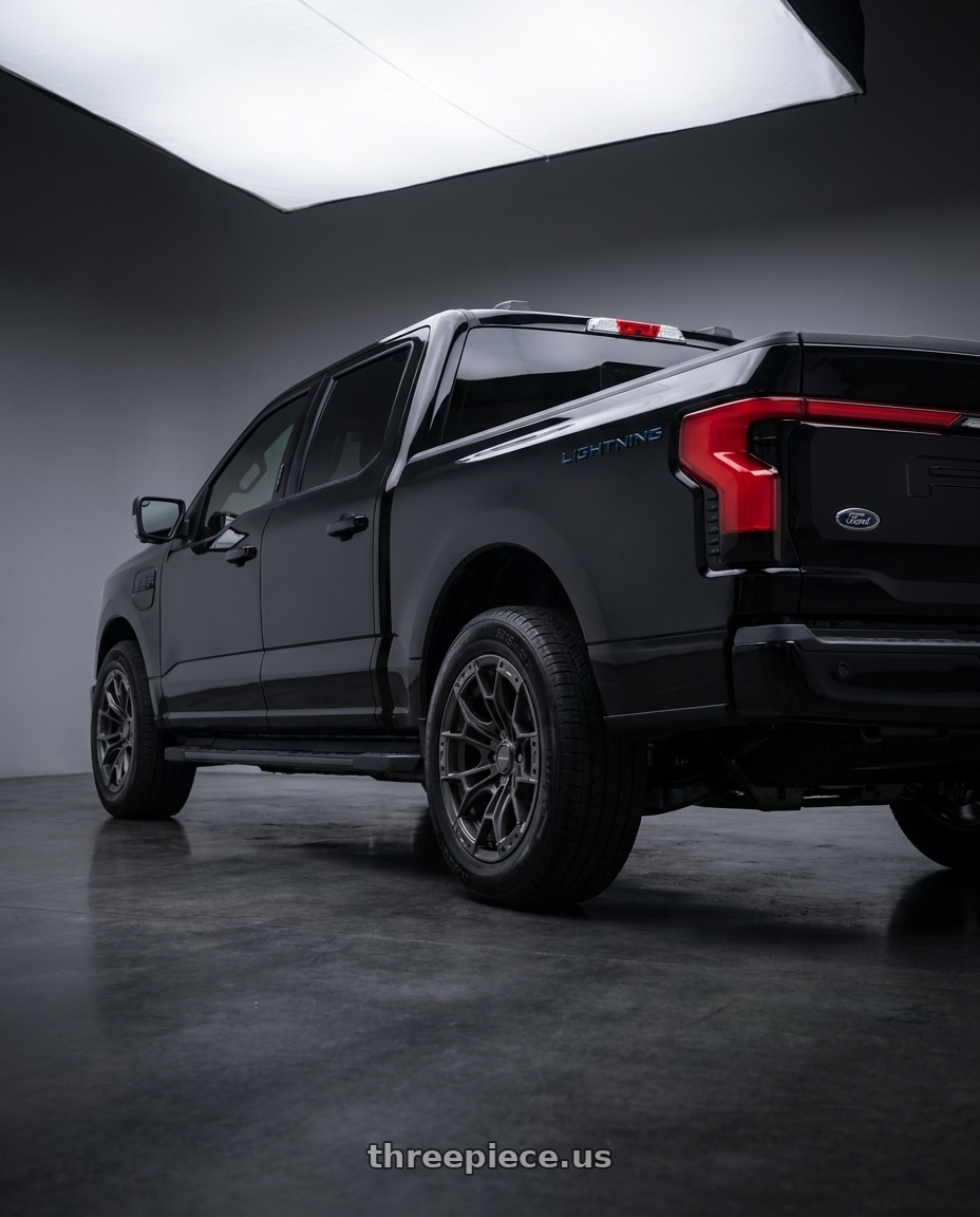 2024 Ford lightning with DEFIANT DF04 6x135 17x9+12 Gunmetal wheels rear three quarter view square tires
