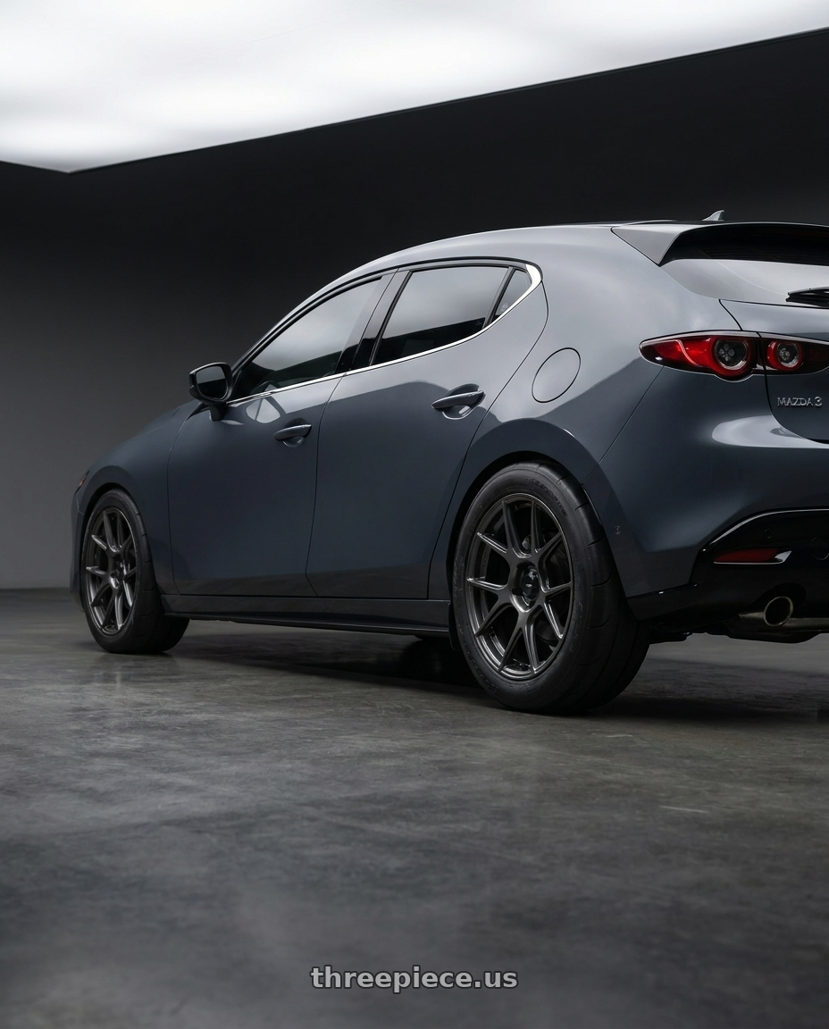 2023 mazda 3 hatchback carbon with Konig Ampliform 5x114.3 18x10+20 Dark Metallic Graphite wheels rear three quarter view excessive tires