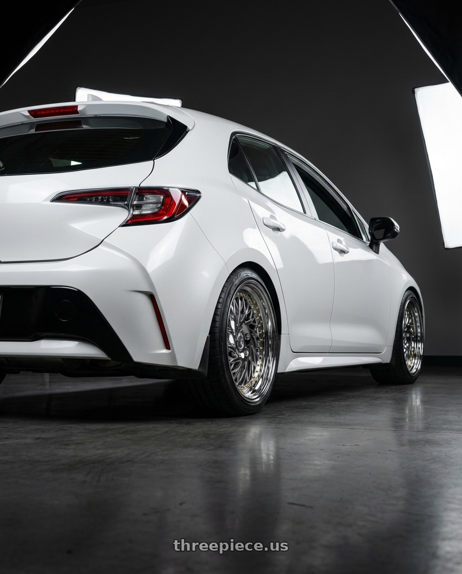2023 Toyota Corolla Hatchback with Aodhan DS03 5x114.3 18x9.5 +30 Vacuum Chrome w/Gold Rivets wheels rear three quarter view square tires
