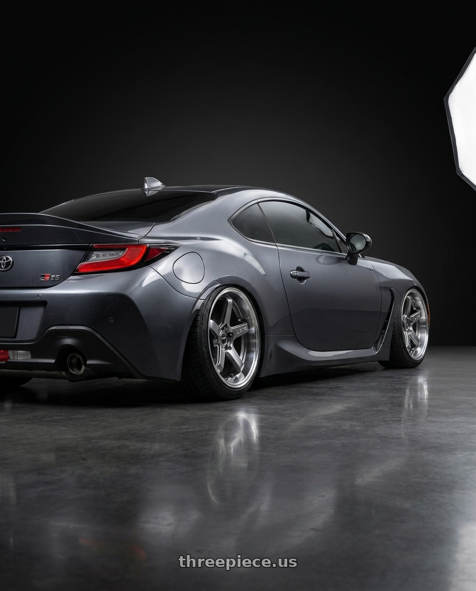 2026 Toyota GR 86 premium with F1R FC5 5x100 18x9.5 +35 Hyper Black/Polish Lip wheels rear three quarter view slight stretch tires