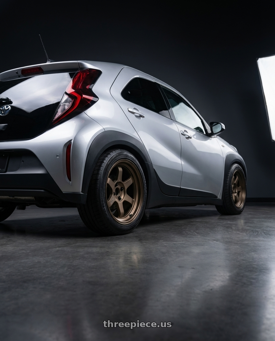 Toyota Aygo X Hybrid 2025 with Volk Racing TE37V 4x100 17x8.5+30 wheels rear three quarter view meaty tires