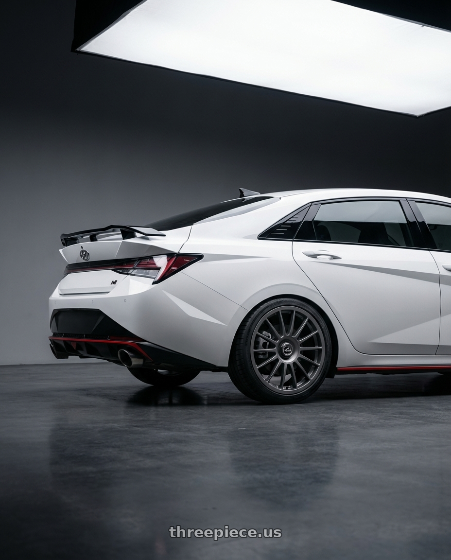 2024 Hyundai Elantra N with fifteen52 PODIUM 5x114.3 / 5x120 19x8.5 +35 FROSTED GRAPHITE (SATIN GREY) wheels rear three quarter view square tires