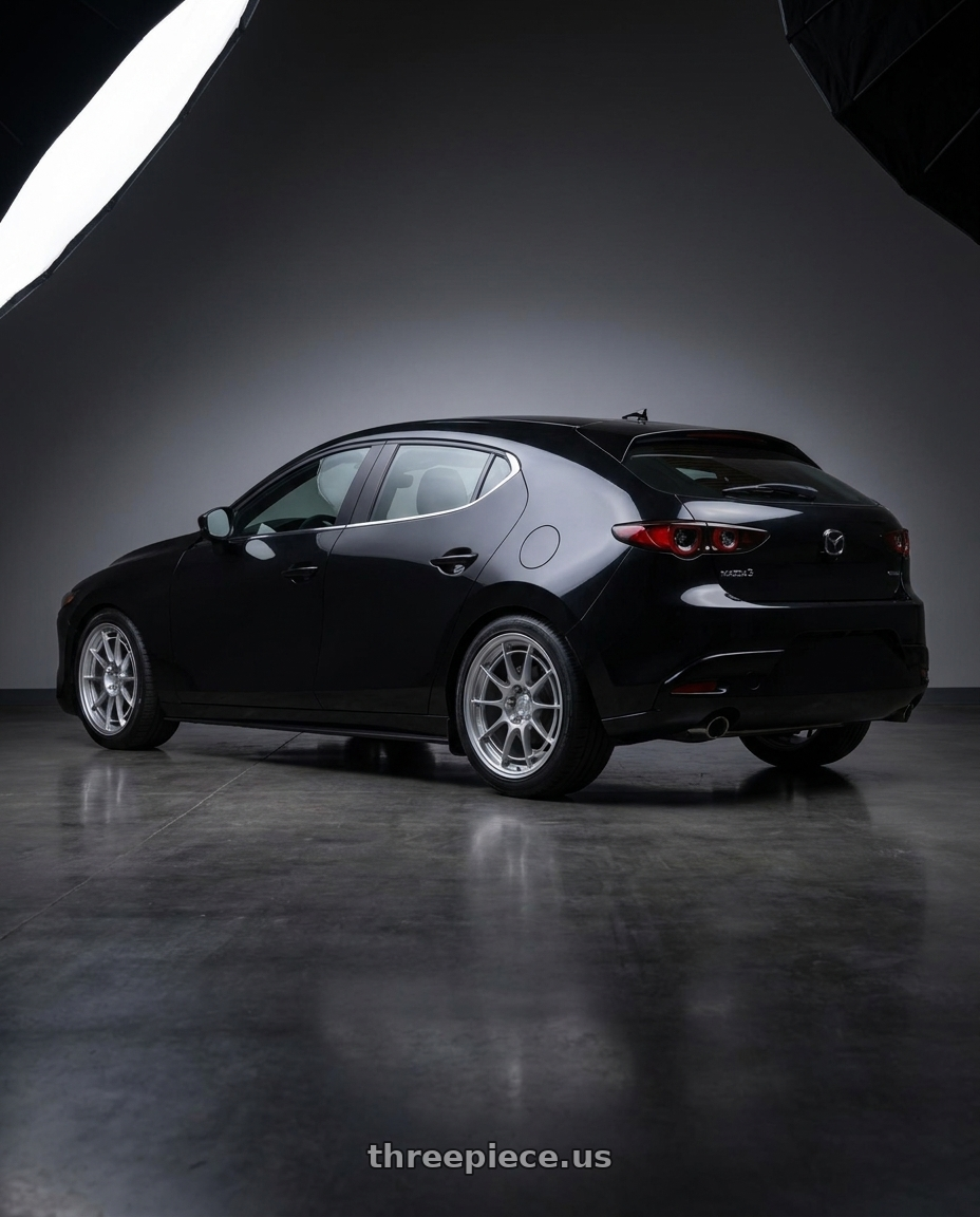 2026 mazda 3 hatchback in with Enkei NT03+M 5x114.3 18x8.5+38 Silver wheels rear three quarter view square tires