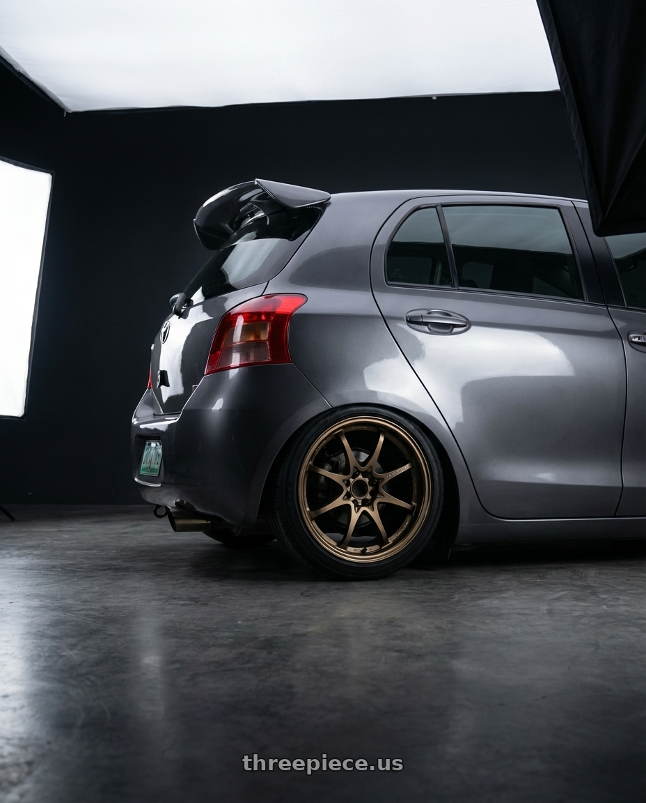 2007 toyota yaris  with Volk Racing CE28N-PLUS 5x114.3 17x7.5 +48 SHINING BRONZE METAL wheels rear three quarter view square tires