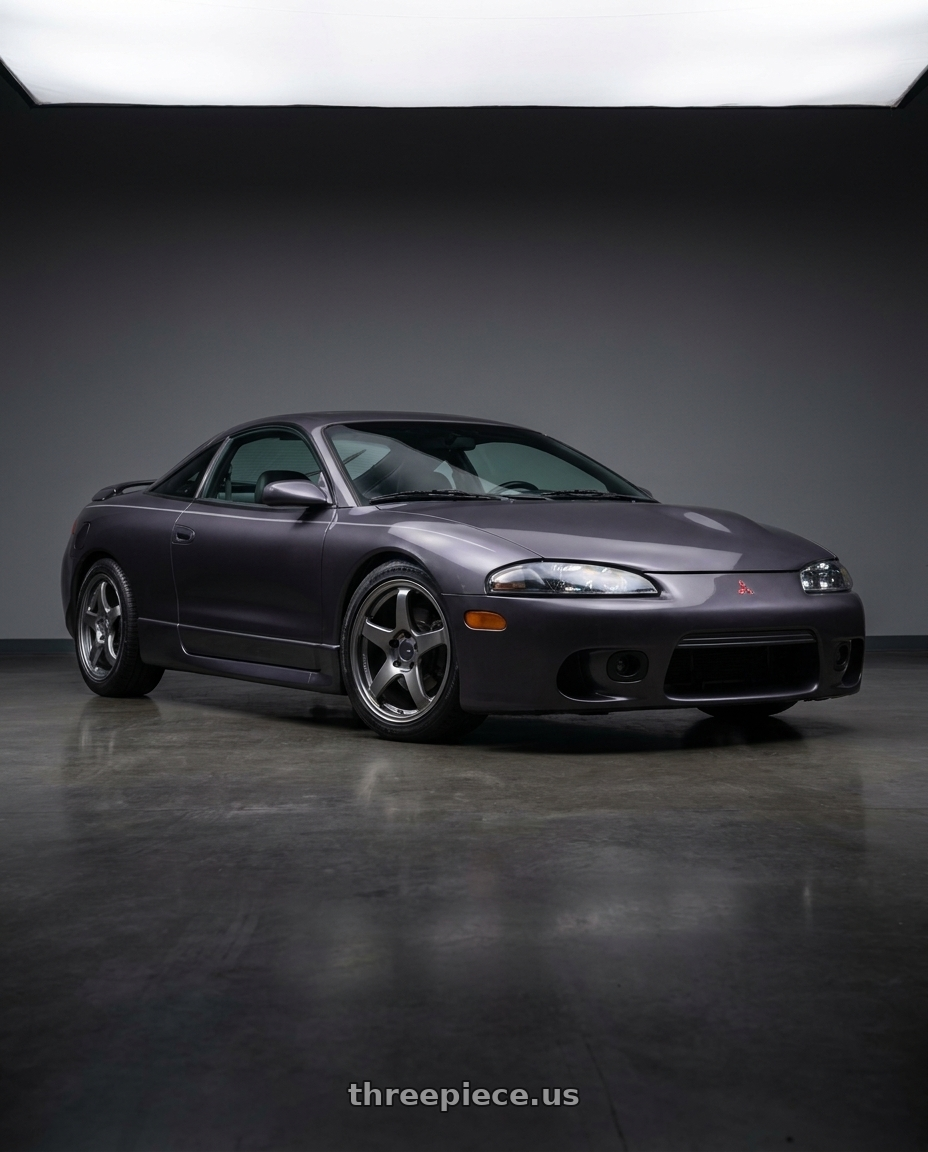 1997 Mitsubishi Eclipse with Enkei PF05 5x114.3 17x7+45 Dark Silver wheels front three quarter view lowered stance