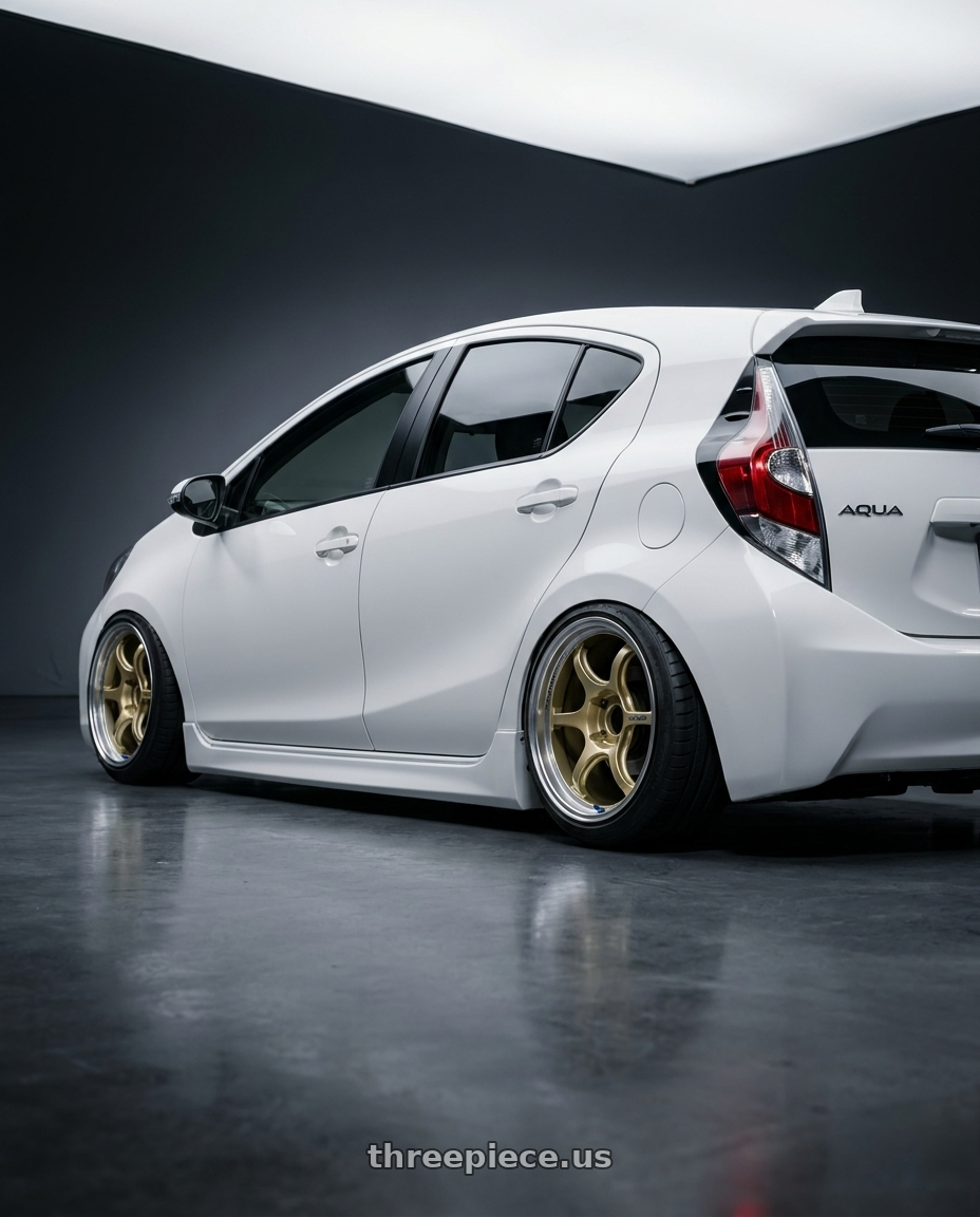 Toyota Aqua 2023 with Advan Racing RG-D2 4x100 15x7.0 +30 MACHINING & CHAMPAGNE GOLD wheels rear three quarter view meaty tires