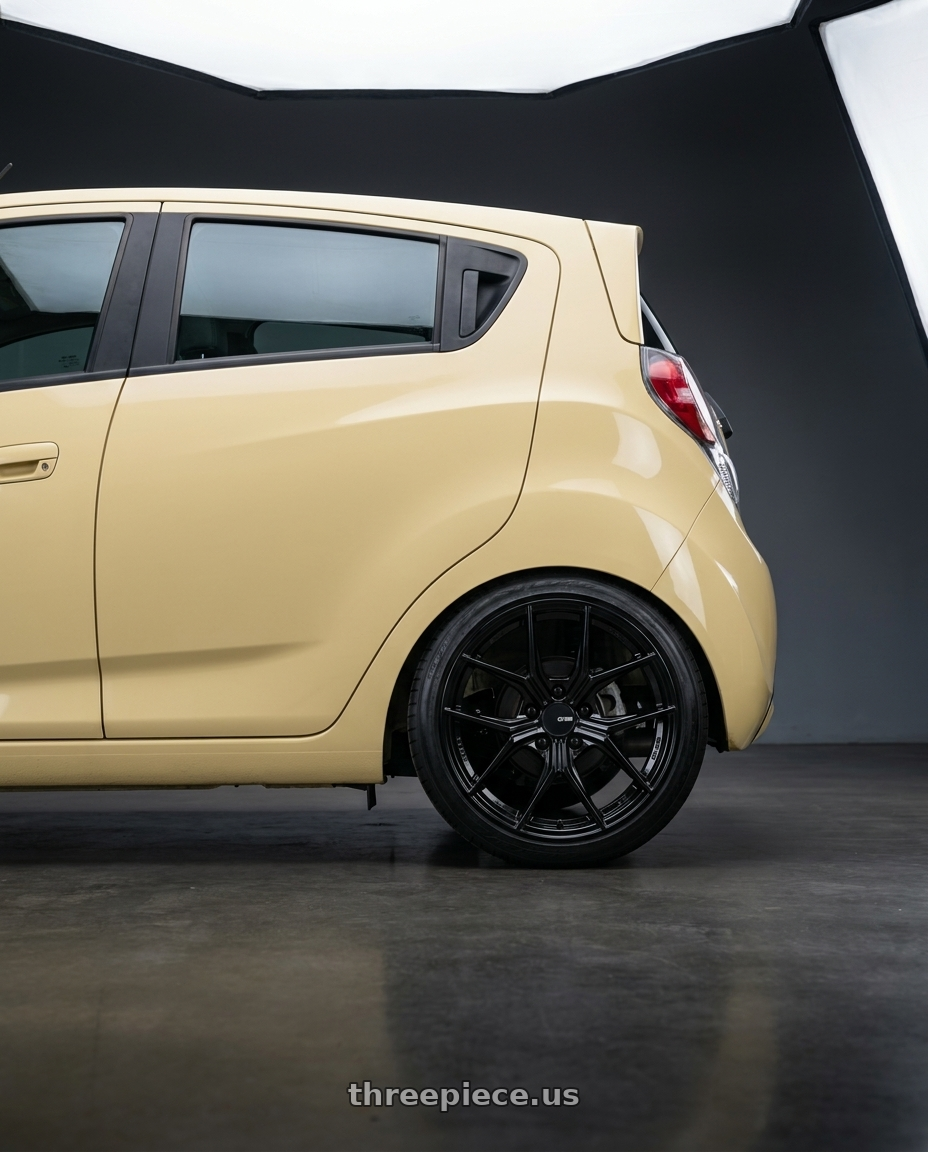 2015 Chevy Spark LT  with Enkei TSR-X 5x100 18x8.5+45 Gloss Black wheels rear three quarter view slight stretch tires