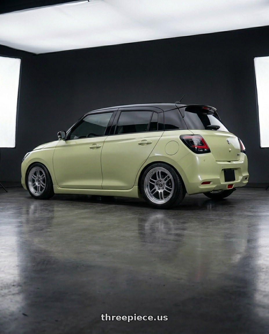 2026 Suzuki Swift with FORMULA AERO SPOKE 4x100 16X7+32 NR Disk Titan Silver wheels rear three quarter view square tires