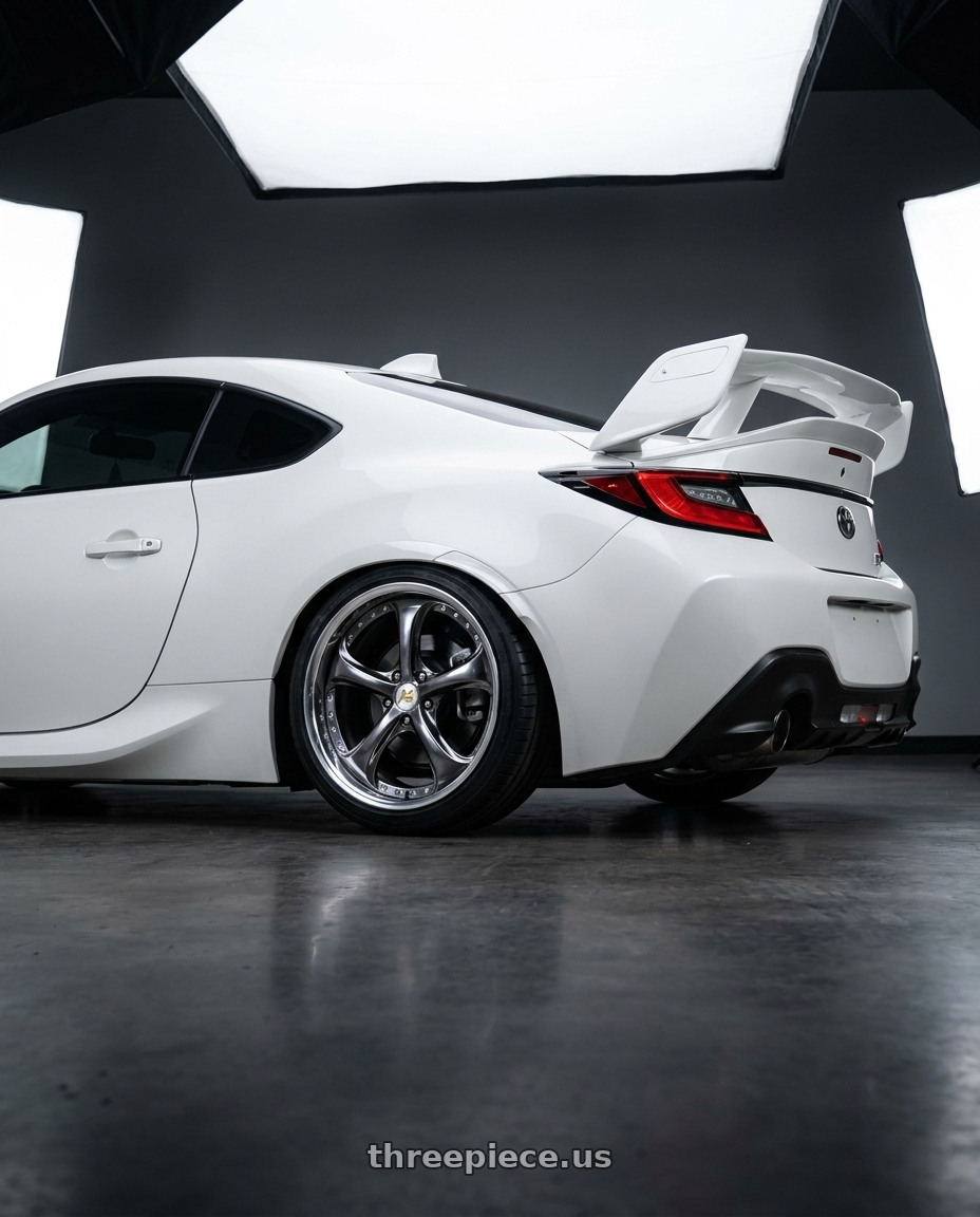 2025 Toyota gr86 base white with Work Wheels VS-KF 5x100 18x9.5+9 Brilliant Silver Black A Disk FULL REVERSE wheels rear three quarter view slight stretch tires