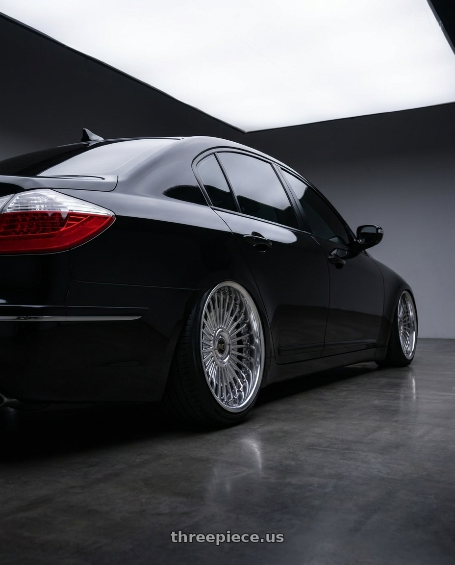 Black 2011 genesis sedan 3.8, tinted and blacked out. Already on coilovers with Work Emitz wheels rear three quarter view extreme stretch tires
