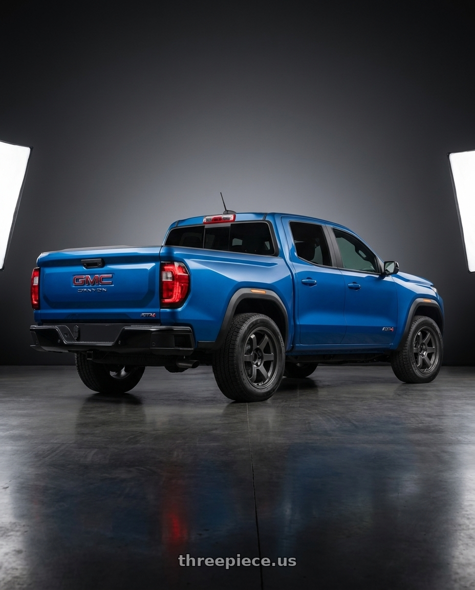 2023 Gmc Canyon Blue with 9six9 SIX-1 Truck 6x139.7 18X9 +0 Carbon Gray wheels rear three quarter view square tires