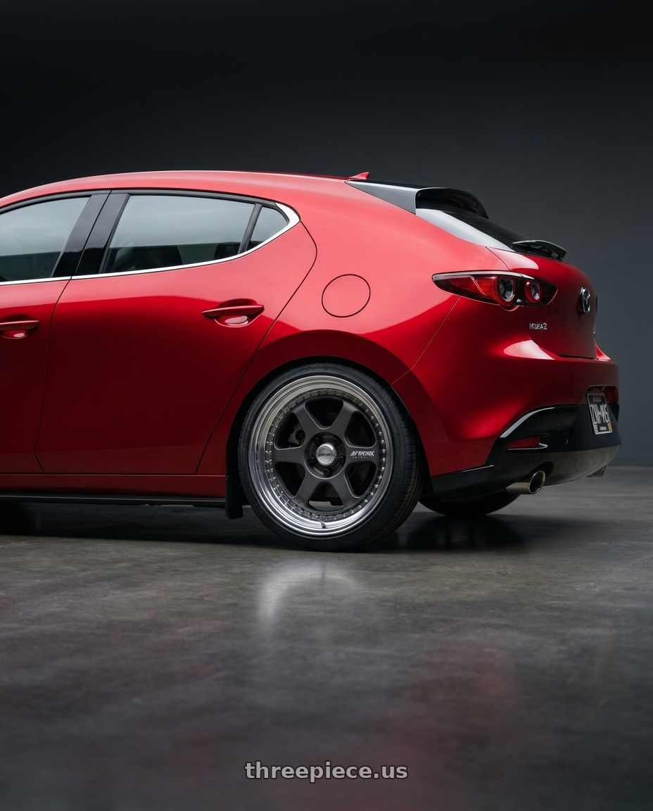 2026 Mazda 3 hatchback soul red with Work Meister L1 3P 5x114.3 18x8.5+38 A Disk Matte Gunmetal wheels rear three quarter view square tires