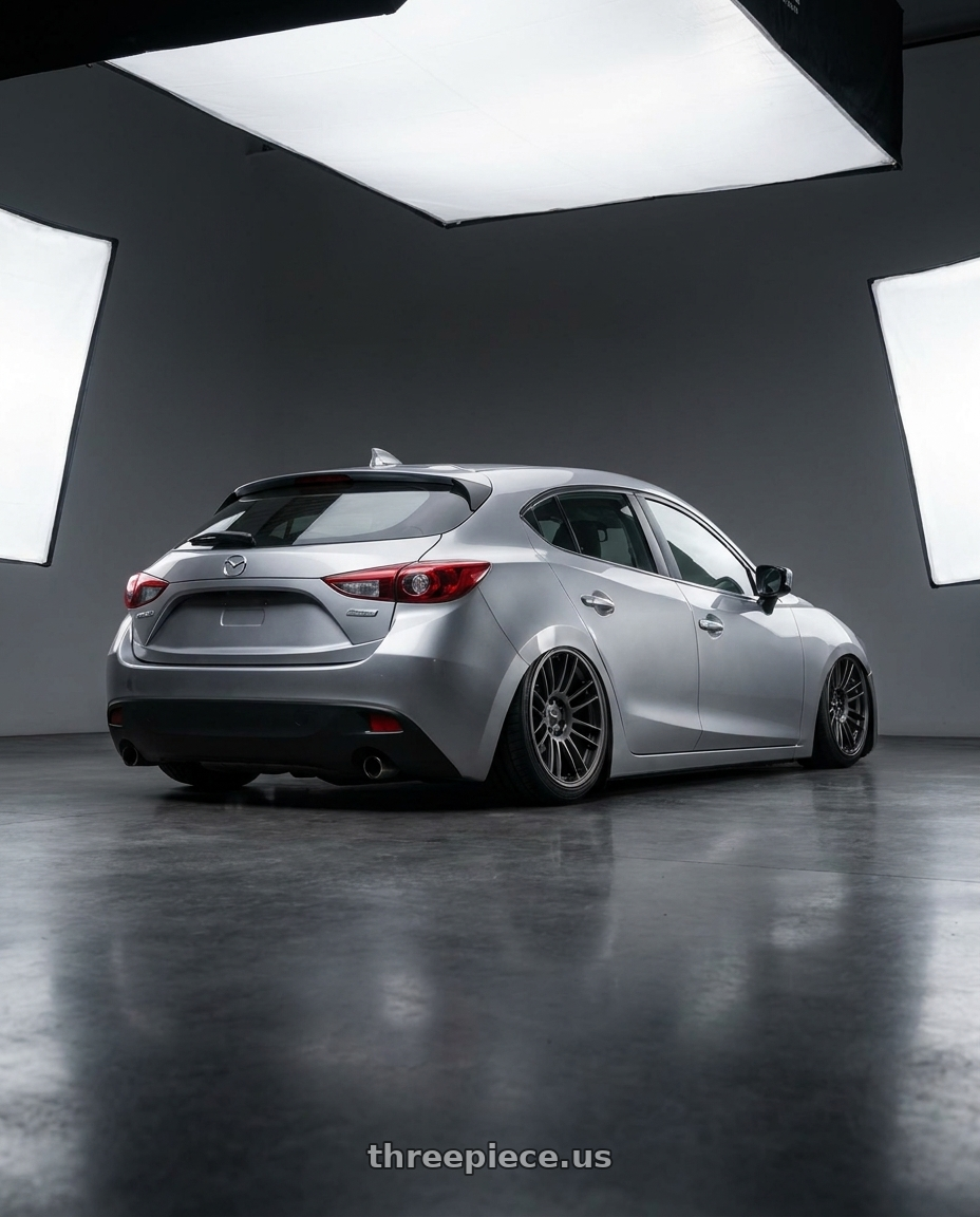 2013 Mazda 3 skyactiv silver with Enkei GTC01RR 5x112 18x8.5+45 Matte Gunmetallic wheels rear three quarter view slight stretch tires