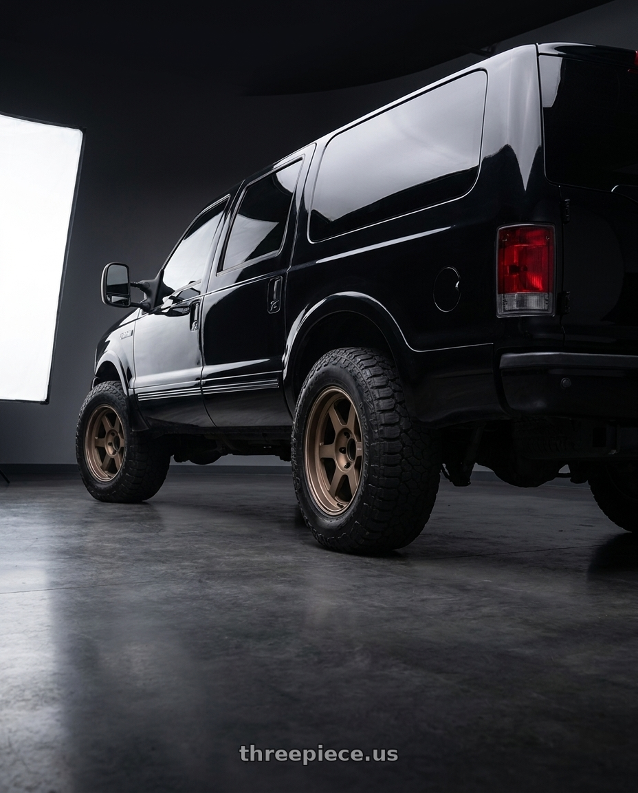 2004 ford excursion with Volk Racing TE37XT 6x139.7 18x9.0+0 Bronze wheels rear three quarter view meaty tires