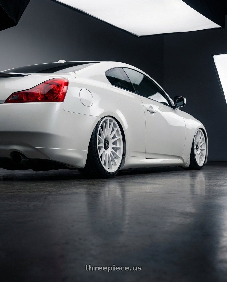 2014 Infiniti G37 Coupe with fifteen52 PODIUM 5x114.3 / 5x120 19x8.5 +35 RALLY WHITE (GLOSS WHITE) wheels rear three quarter view slight stretch tires