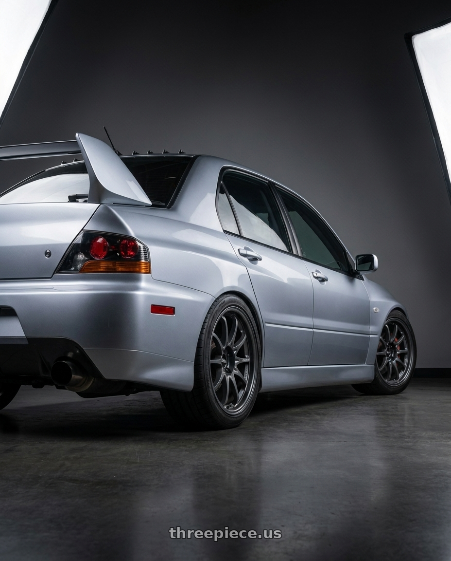 2005 Mitsubishi Evo with Volk Racing CE28N-PLUS M-SPEC 5x112 18x9 +38 BLAST GUNMETAL wheels rear three quarter view square tires