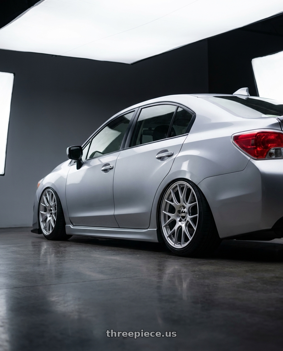 2016 Subaru impreza with BBS RE-V7 5x112 18x8.5 +42 Diamond Silver wheels rear three quarter view slight stretch tires