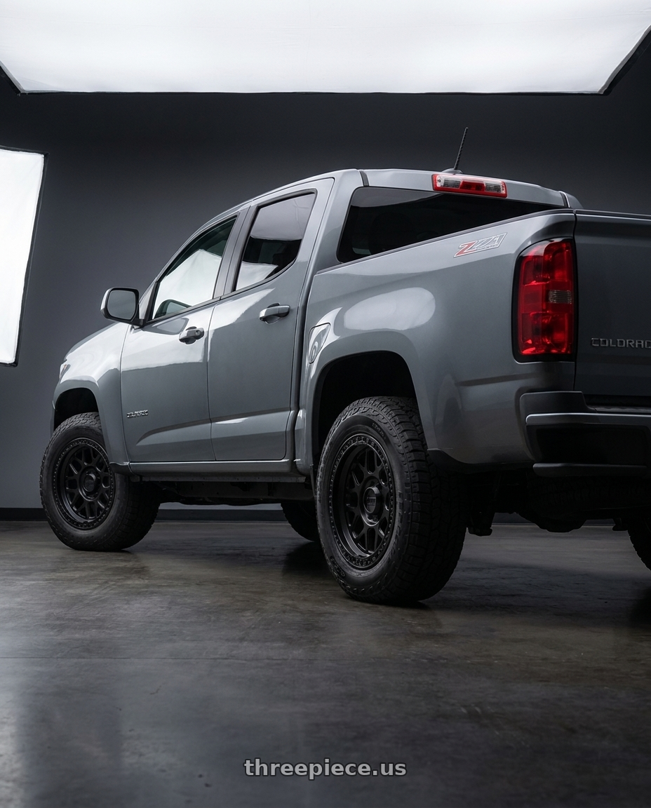 2021 Chevrolet Colorado WT with KMC KM549 GRS 6X120 17X8.5 +0 SATIN BLACK wheels rear three quarter view square tires