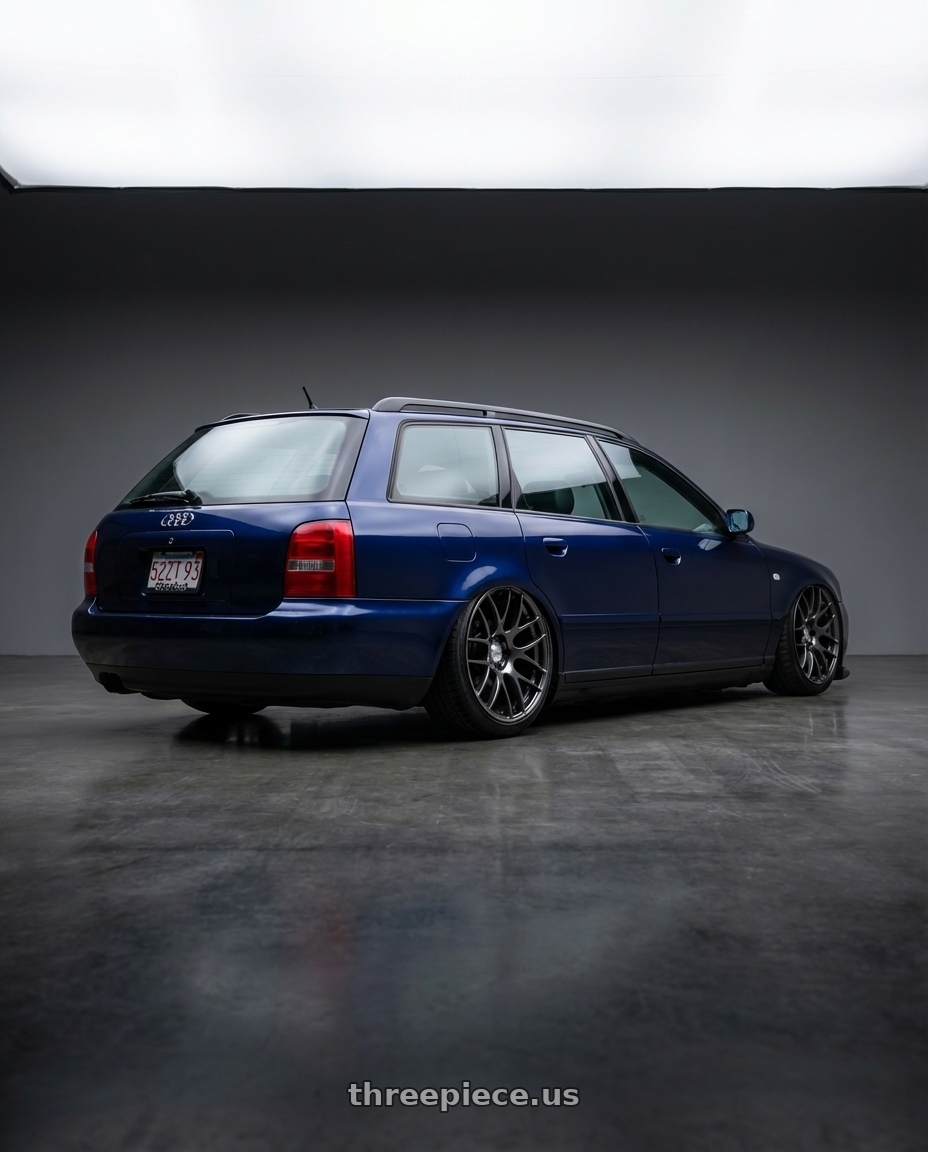 1999 Audi A4 Avant with Work Emotion m8r 5x100 18x8.5 +48 Glim Black wheels rear three quarter view slight stretch tires