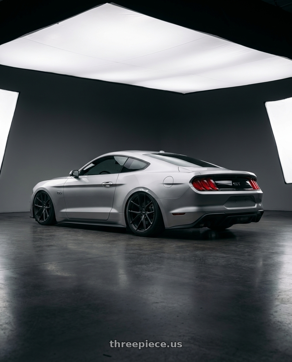 2018 Ford mustang with Bravado 08B Tribute 5X115 20x9.5 +18 Matte Black wheels rear three quarter view slight stretch tires