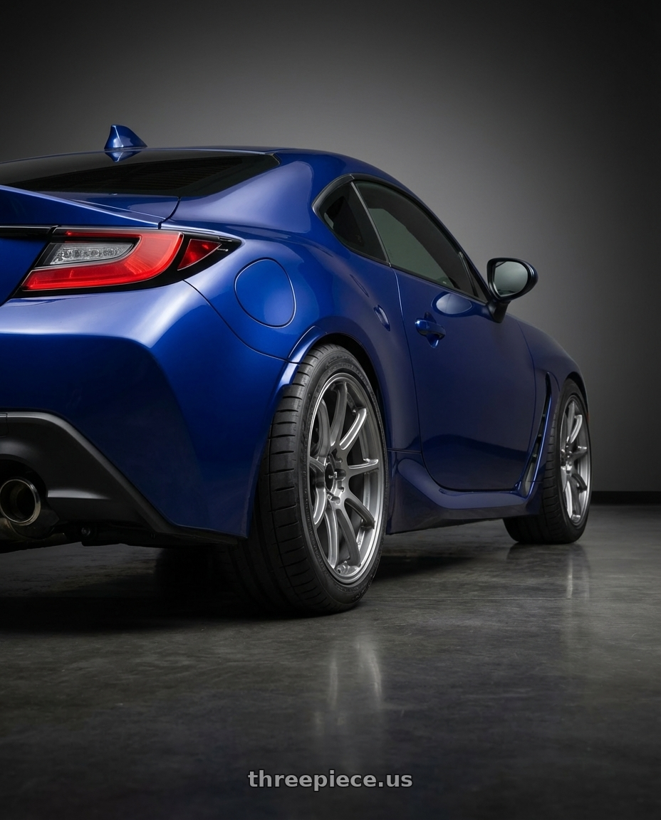 2023 Toyota GR86 with Enkei Triumph 5x100 18x8.5+45 Storm Gray wheels rear three quarter view meaty tires