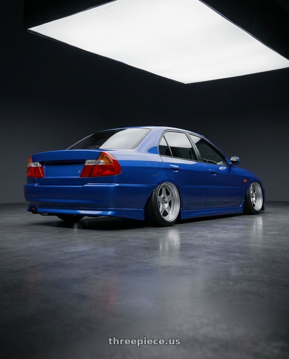 1996 Mitsubishi Lancer Base with Kansei K11S Tandem 5x114.3 17x9 35 Hyper Silver wheels rear three quarter view extreme stretch tires
