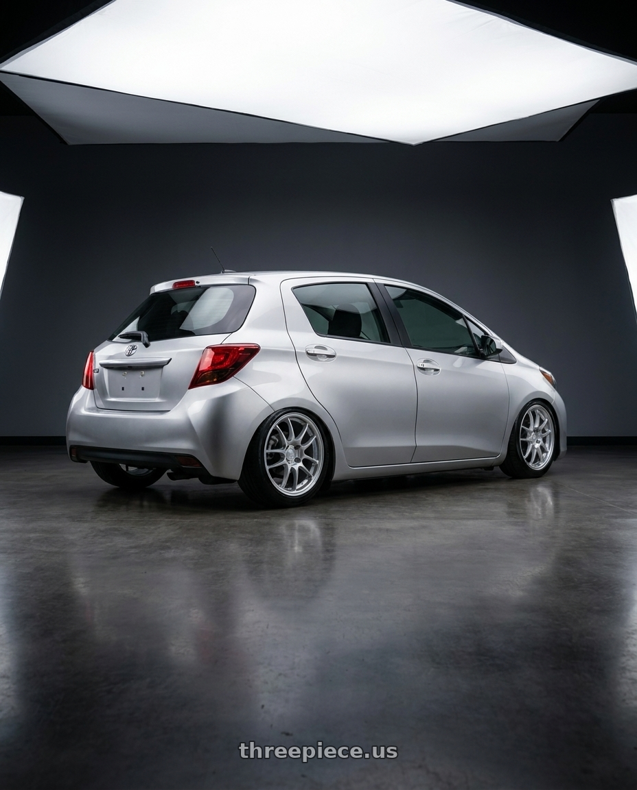 2015 Yaris toyota with Enkei PF01 4x100 16x7+43 Silver wheels rear three quarter view slight stretch tires