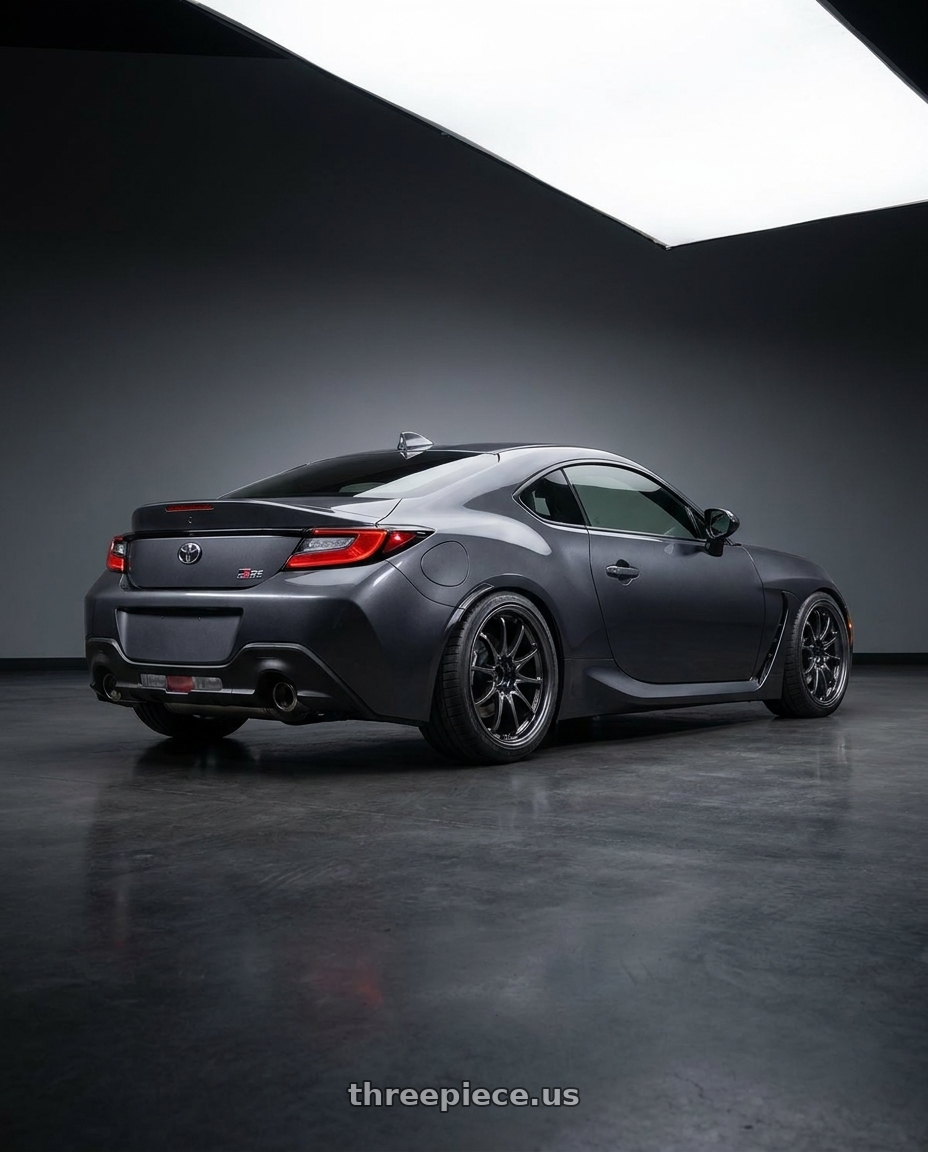 2023 Toyota gr86 with Volk Racing CE28N-PLUS 5x114.3 18x10 +40 DIAMOND DARK GUNMETAL wheels rear three quarter view slight stretch tires