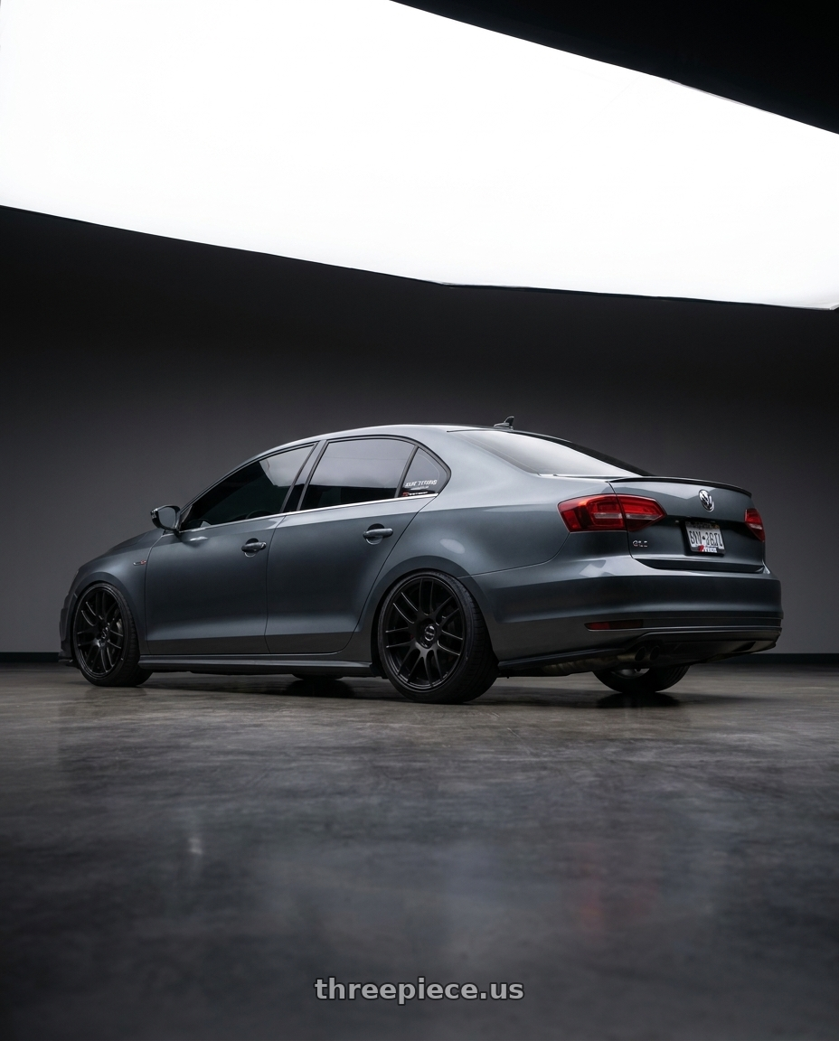 2016 VW Jetta gli with Work Emotion m8r 5x114.3 18x8.5 +35 Matte Black wheels rear three quarter view slight stretch tires